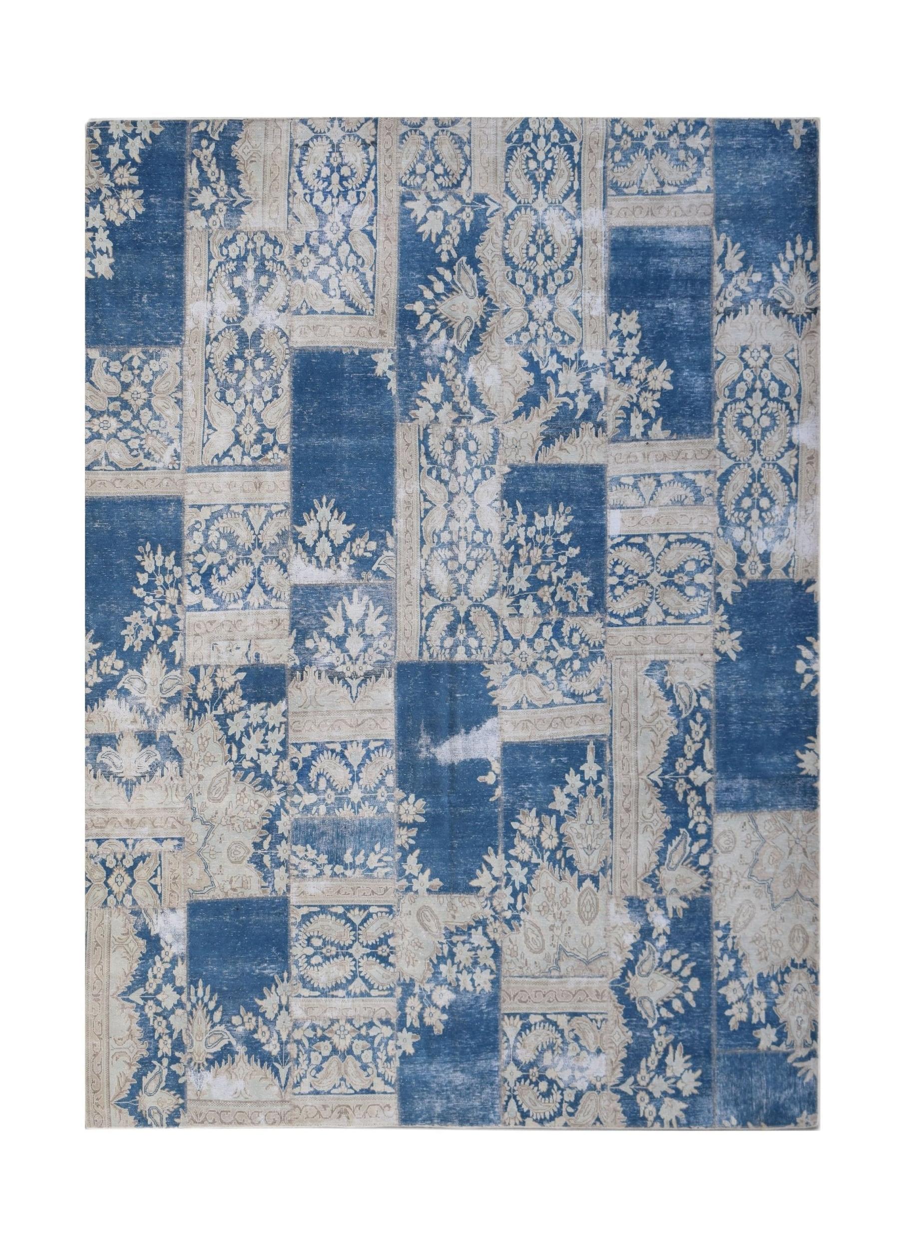 A rectangular patchwork rug featuring a vintage blue and cream floral pattern.