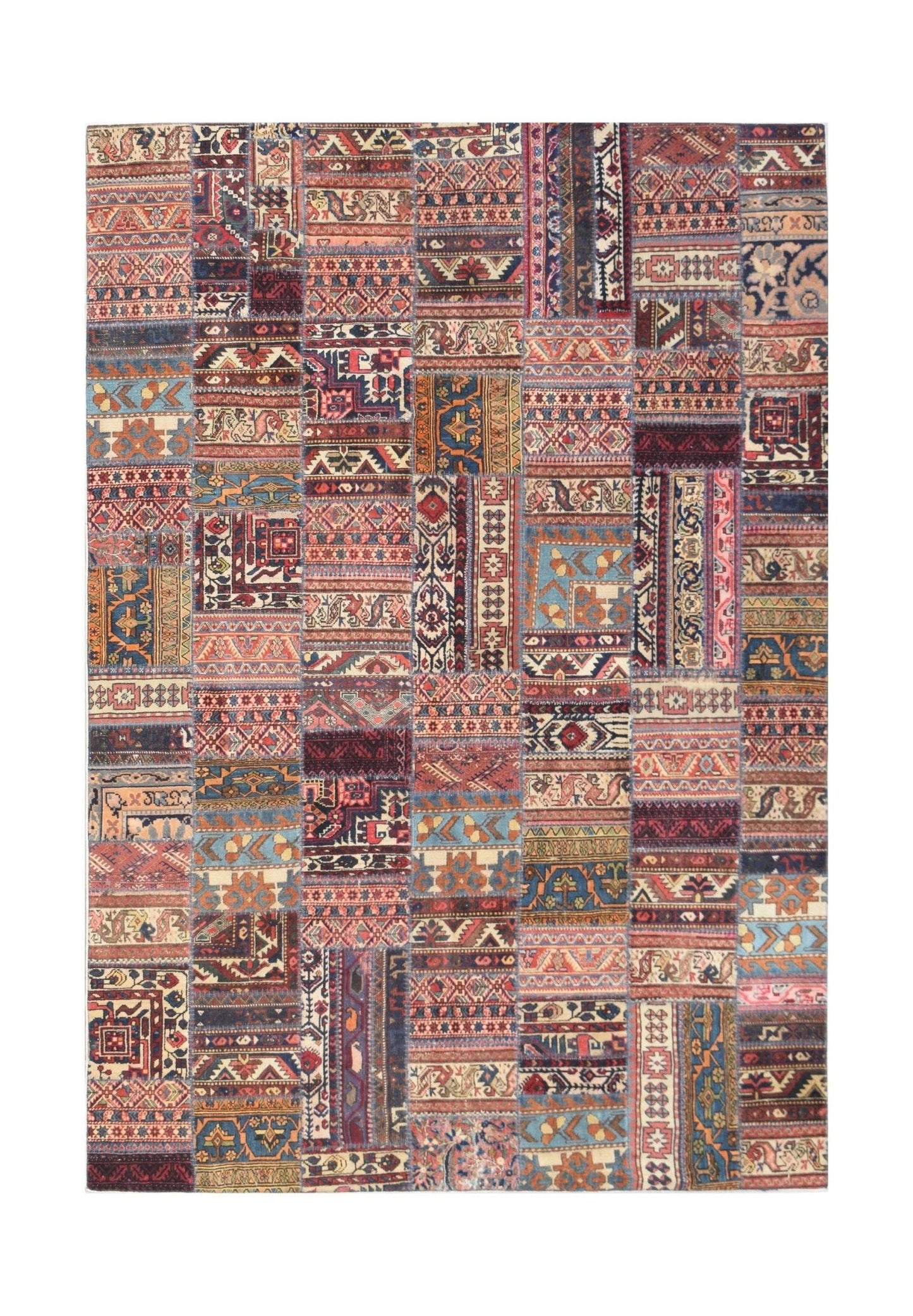 A rectangular handmade patchwork rug featuring a vibrant collage of vintage wool carpet fragments.