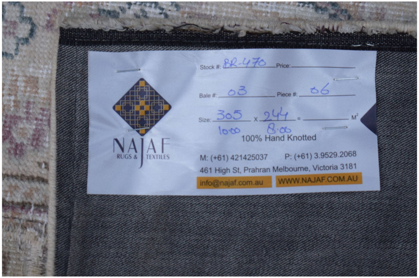 The underside of a vintage patchwork rug showing a Najaf Rugs and Textiles label.