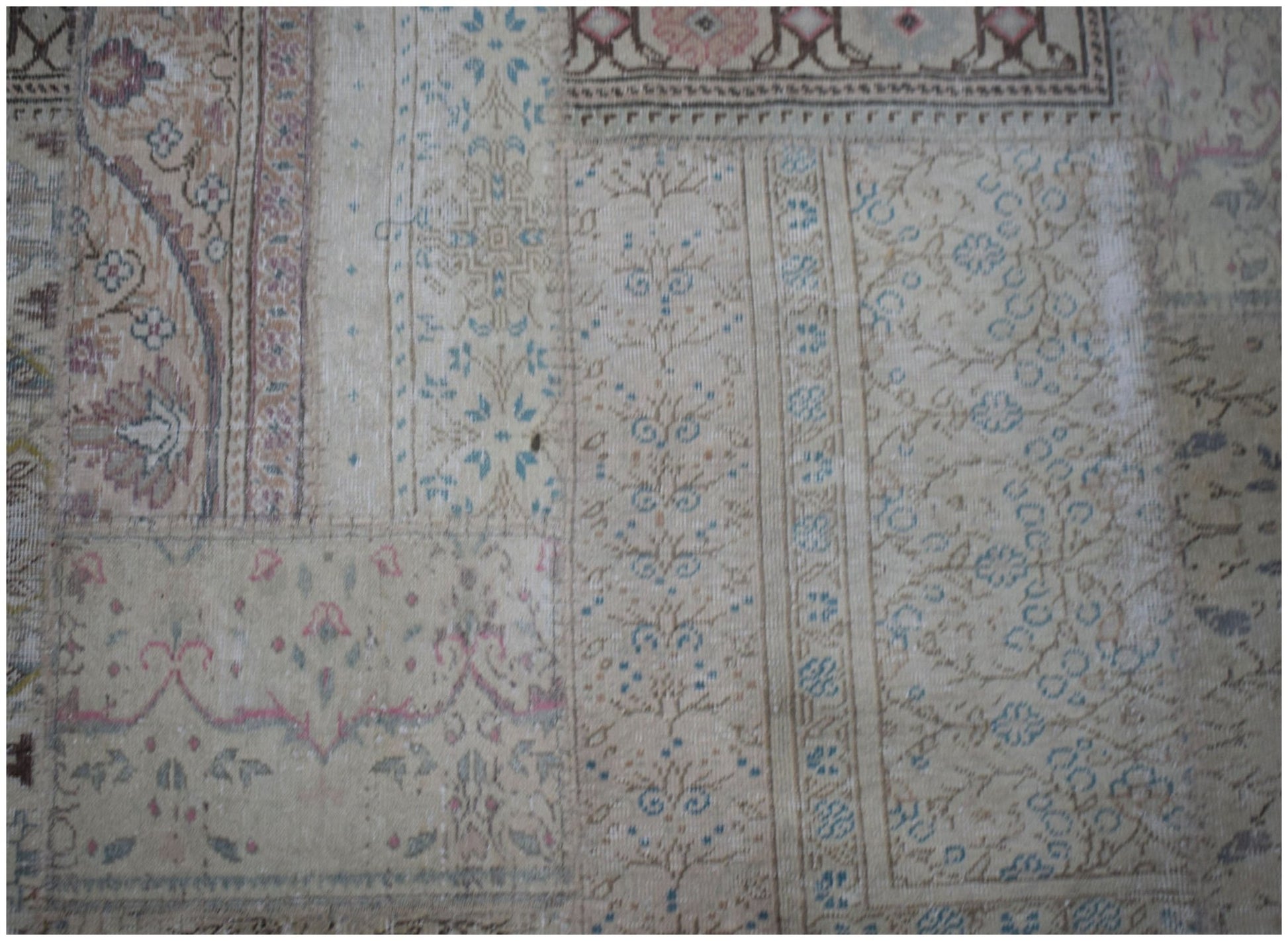 A handmade vintage patchwork rug featuring a neutral color palette with intricate floral patterns.