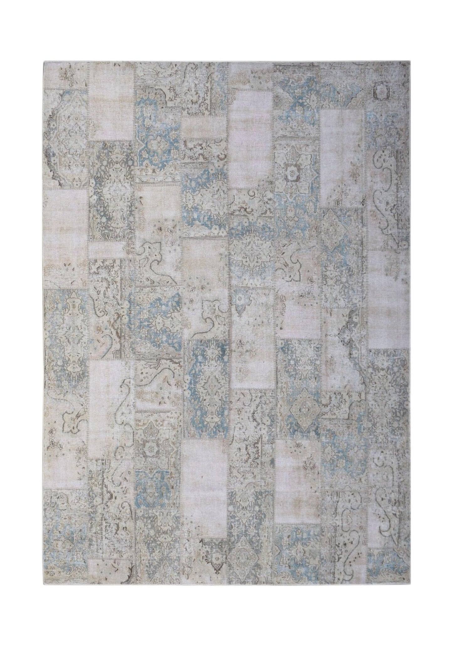 A handmade vintage patchwork rug featuring a faded blue and beige traditional pattern.