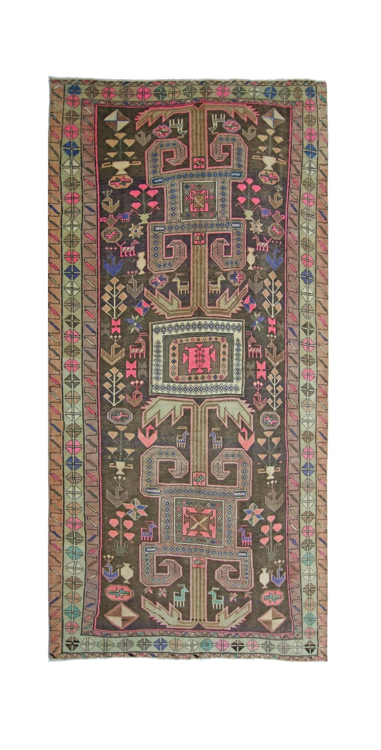 A vintage handmade Persian Ardabil rug featuring a dark field with geometric motifs and colorful accents.