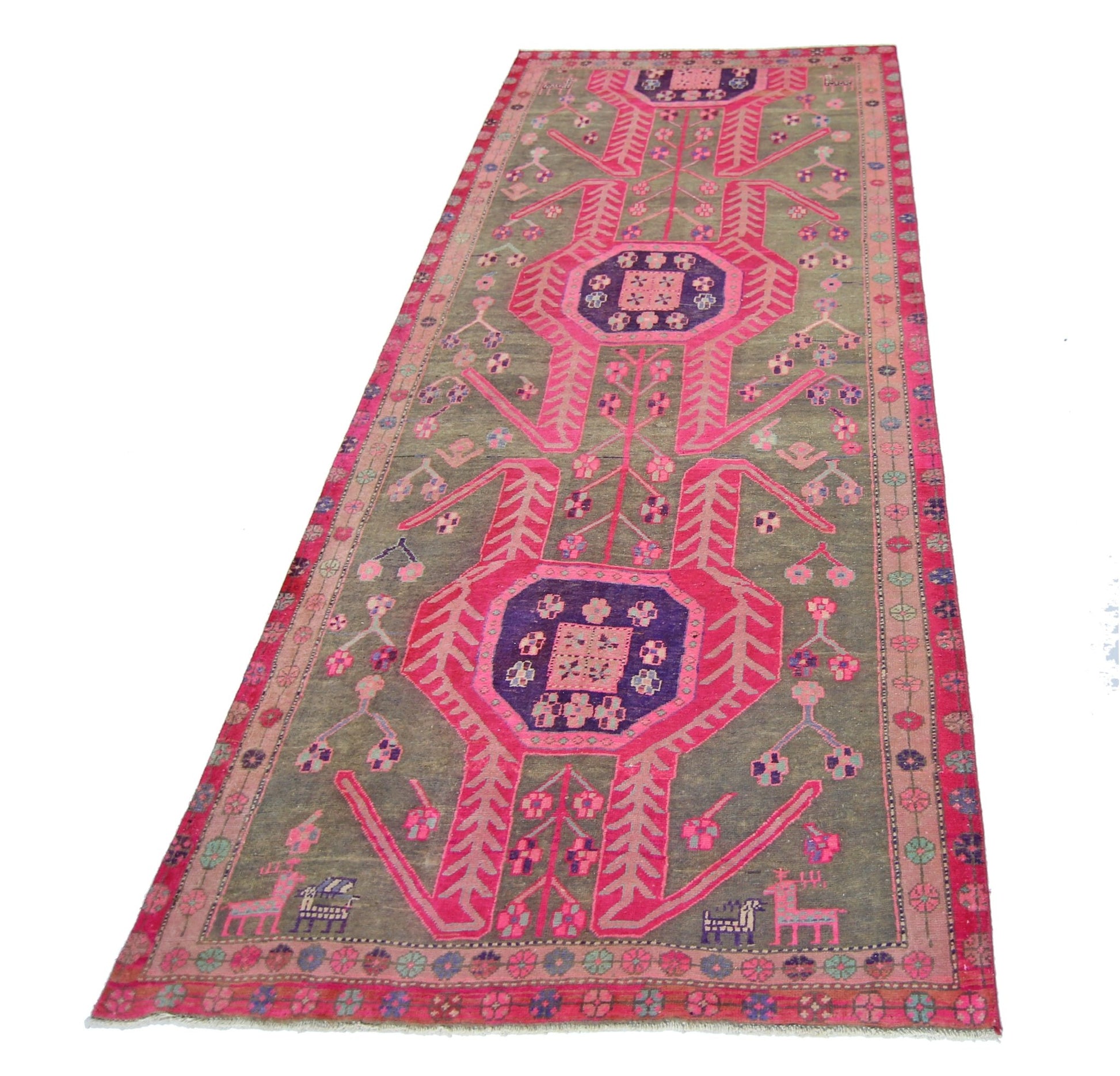 A vintage Persian Ardabil runner rug featuring geometric pink and purple motifs on a grey field.