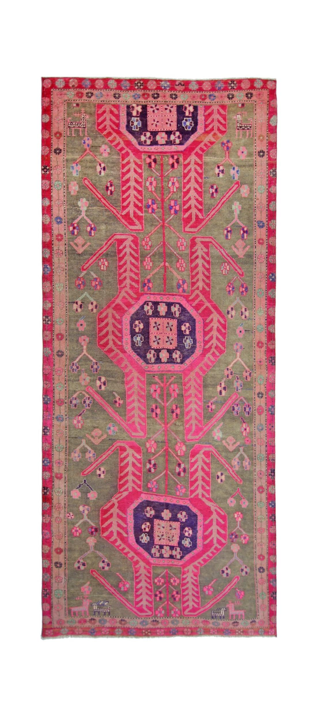A vintage Persian Ardabil rug featuring a vibrant pink and grey geometric floral pattern.