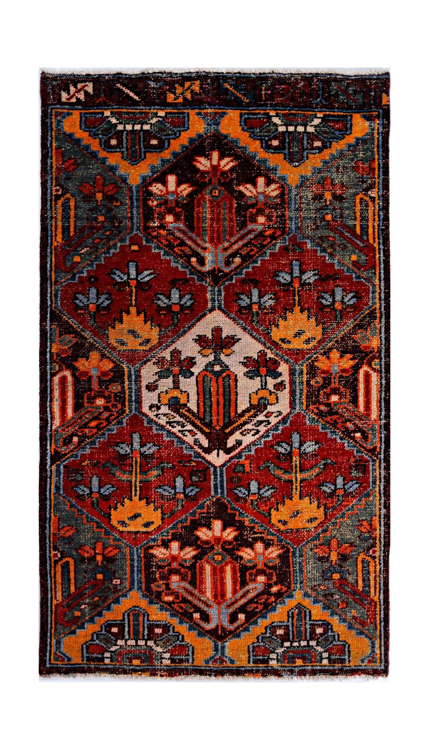A vintage Persian Bakhtiari rug featuring a geometric floral pattern in red, blue, and orange.