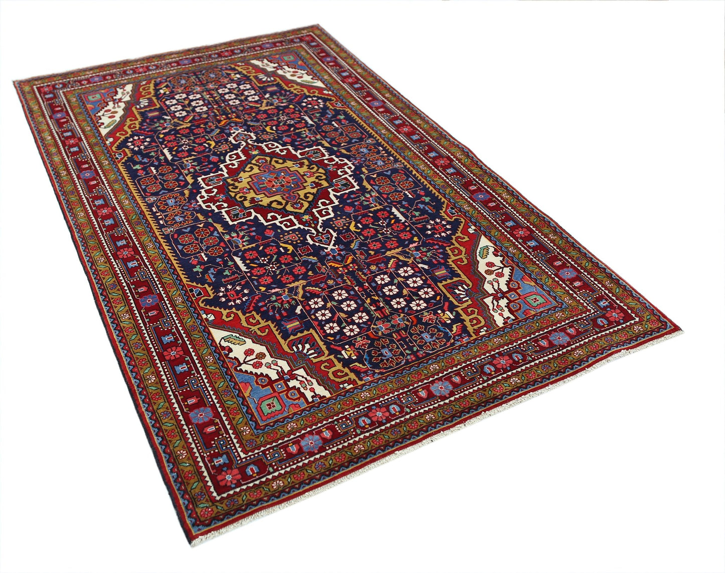 A vintage Persian Bakhtiari rug featuring a dark blue field with intricate floral and geometric motifs.