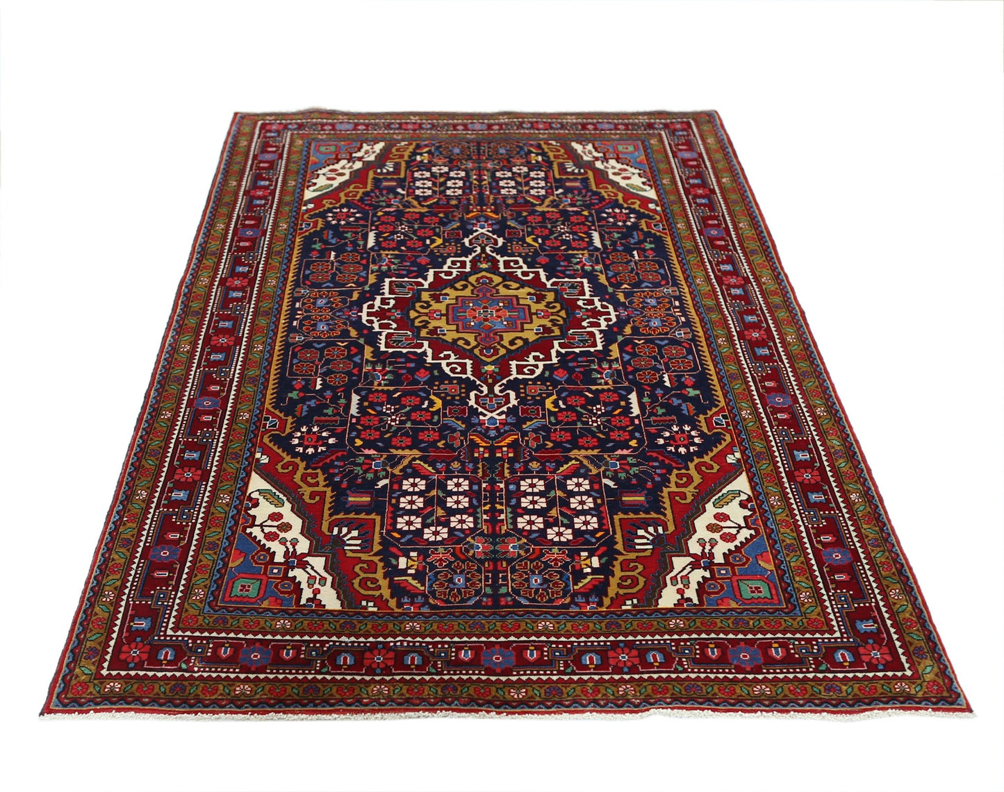 A vintage Persian Bakhtiari rug featuring a central medallion on a dark blue field with floral motifs.