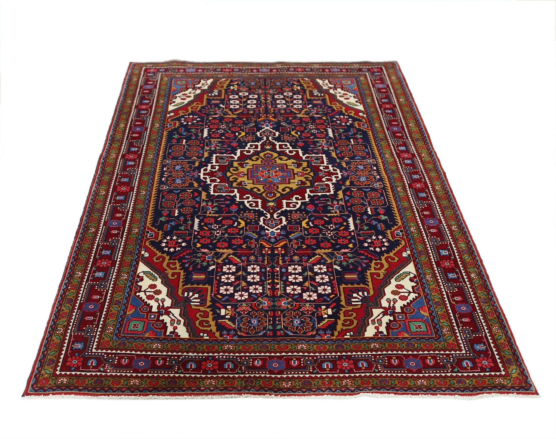 A vintage Persian Bakhtiari rug featuring a central medallion on a dark blue field with floral motifs.