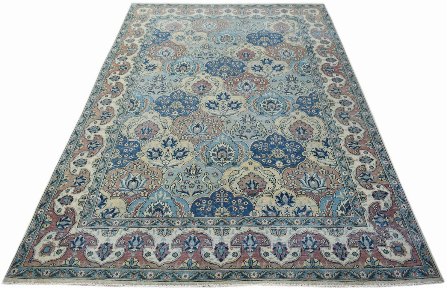 A vintage Persian Bakhtiari rug featuring a blue and cream floral pattern with a decorative border.