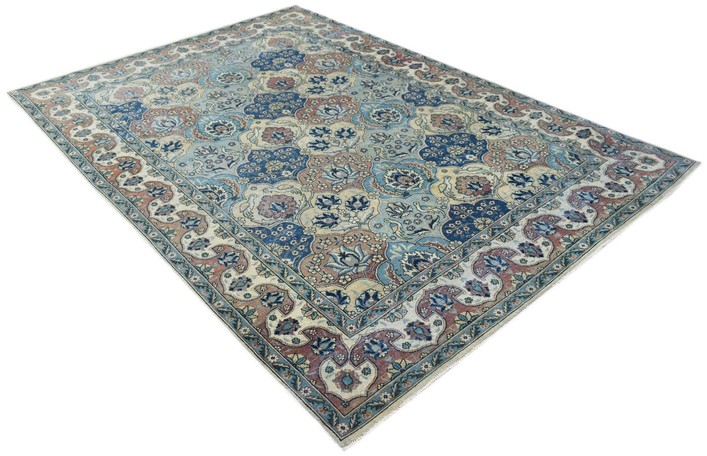 A vintage Persian Bakhtiari rug featuring a traditional floral pattern in blue, cream, and red.
