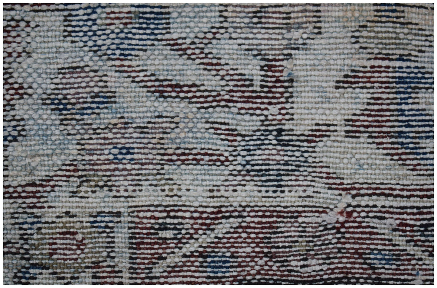 A close-up view of a vintage Persian Bakhtiari rug featuring intricate handwoven wool patterns.