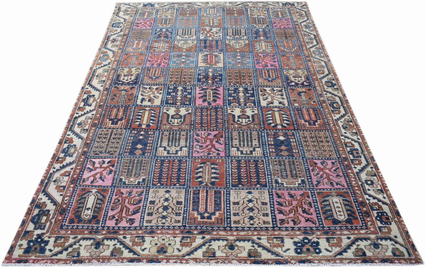 A vintage Persian Bakhtiari rug featuring a colorful grid of geometric and floral motifs.
