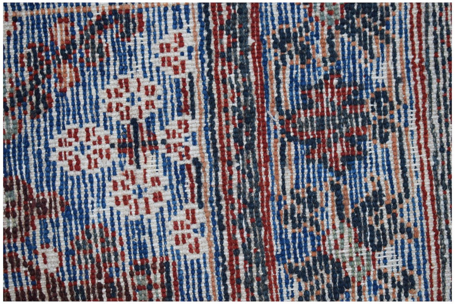 A close-up view of a vintage Persian Ghashghai rug featuring intricate geometric floral patterns.