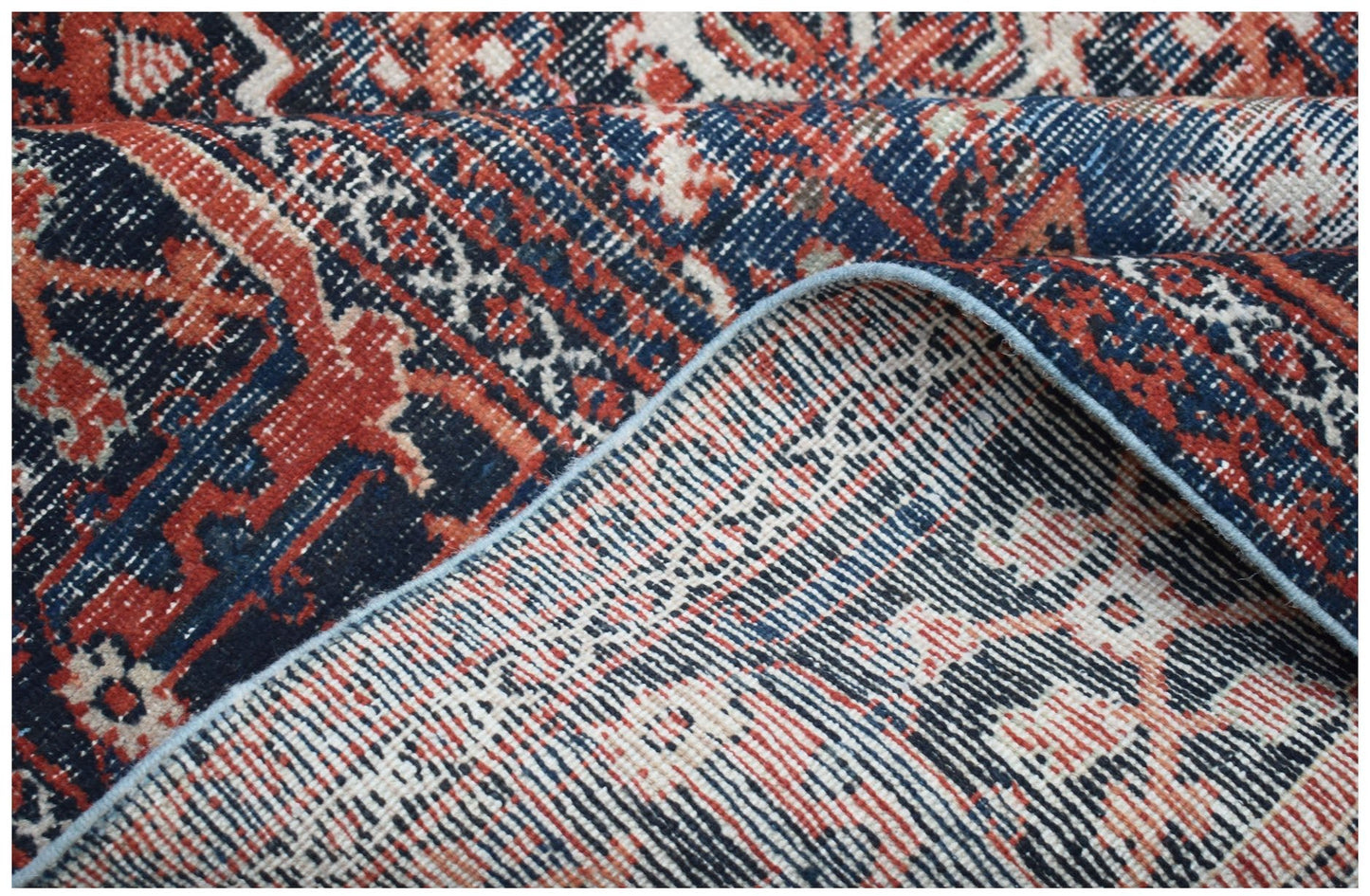 Vintage Persian Ghashghai rug with red, blue, and cream geometric patterns.