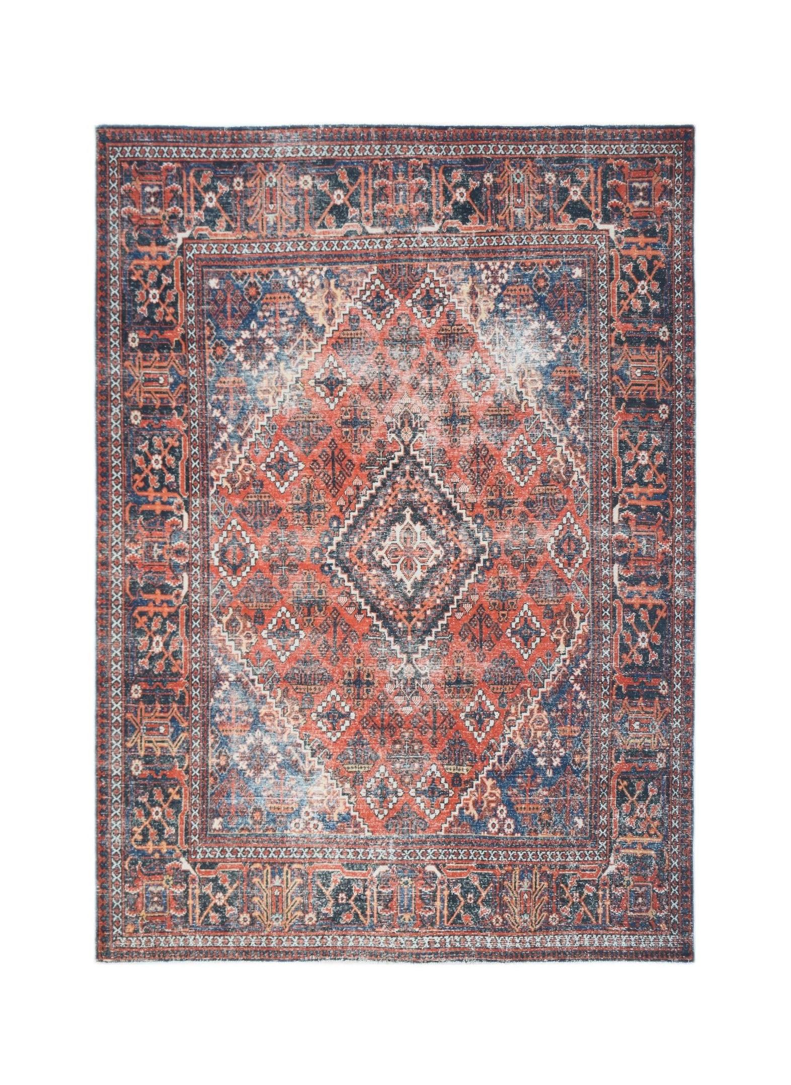 A vintage Persian Ghashghai rug featuring a traditional geometric pattern in red and blue tones.