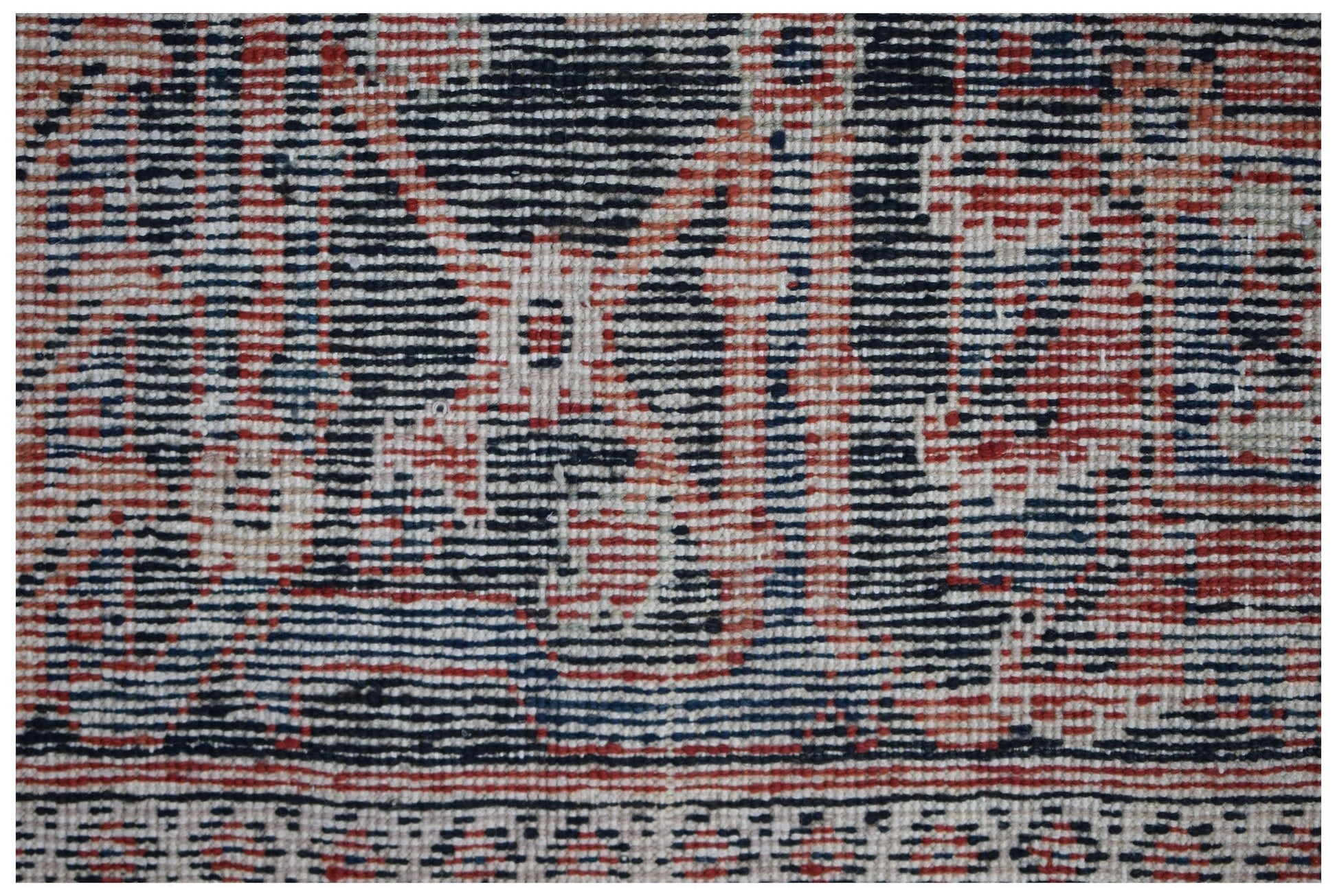 A close-up of a vintage Persian Ghashghai rug featuring intricate geometric patterns in wool.