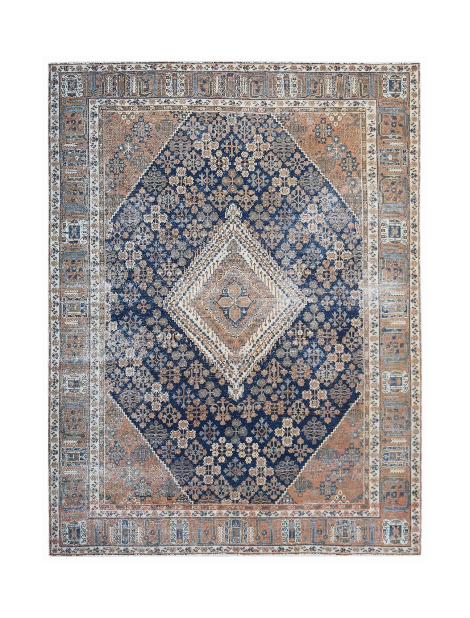 A vintage Persian Ghashghai rug featuring a central diamond medallion in blue and terracotta tones.