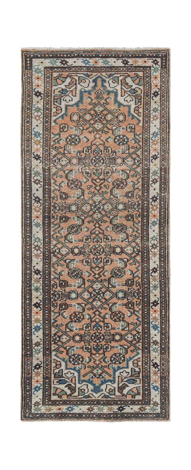 Vintage Persian runner with a peach field and geometric patterns.