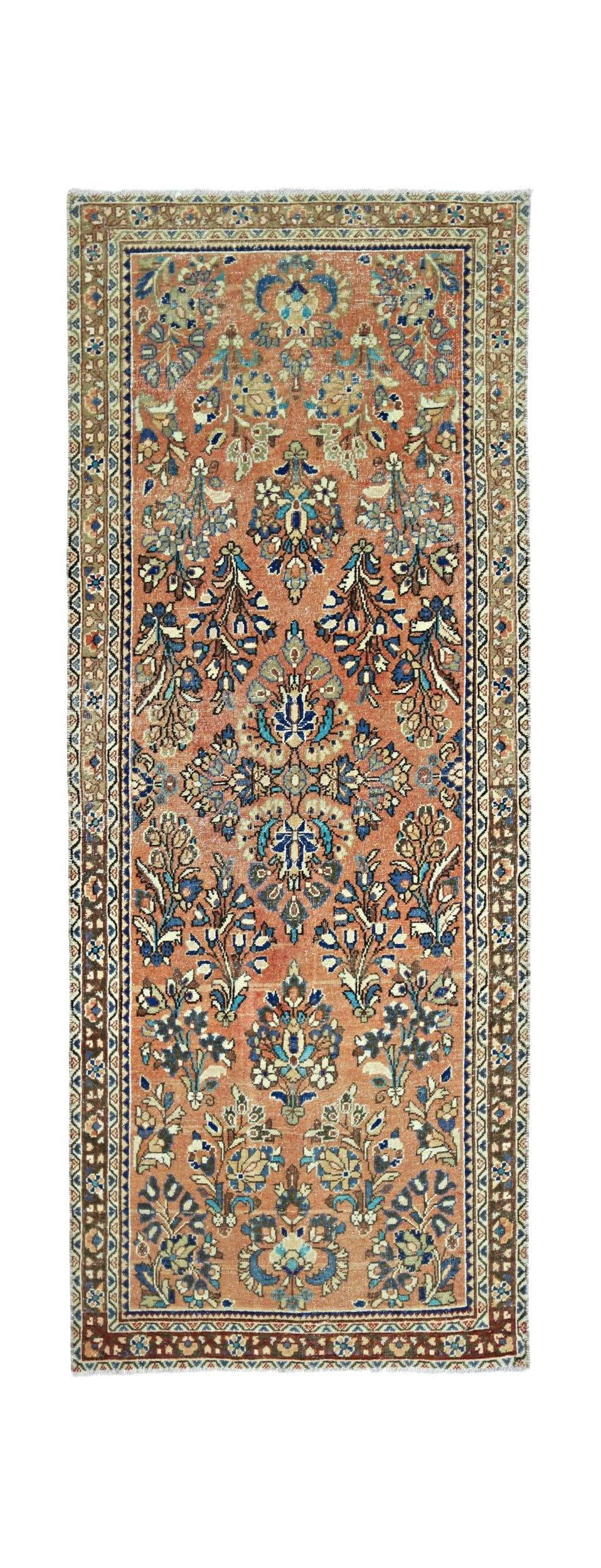 A vintage Persian runner featuring a floral pattern in shades of orange, blue, and cream.