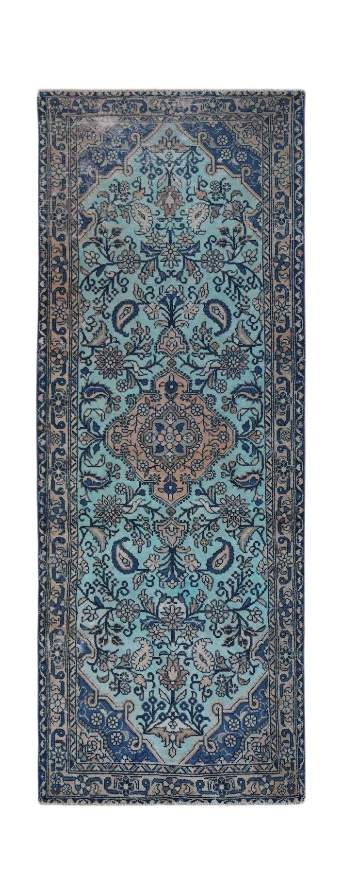 A vintage handwoven Persian runner rug featuring a floral pattern in shades of blue and tan.