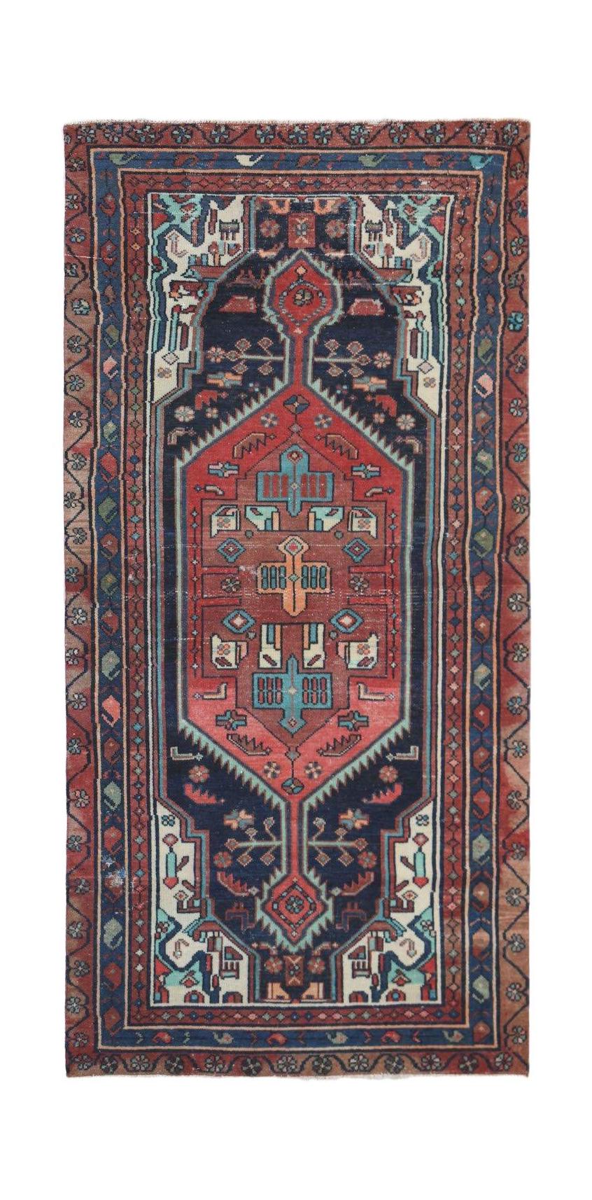 A handwoven vintage Persian runner featuring a geometric medallion pattern in red and navy blue.