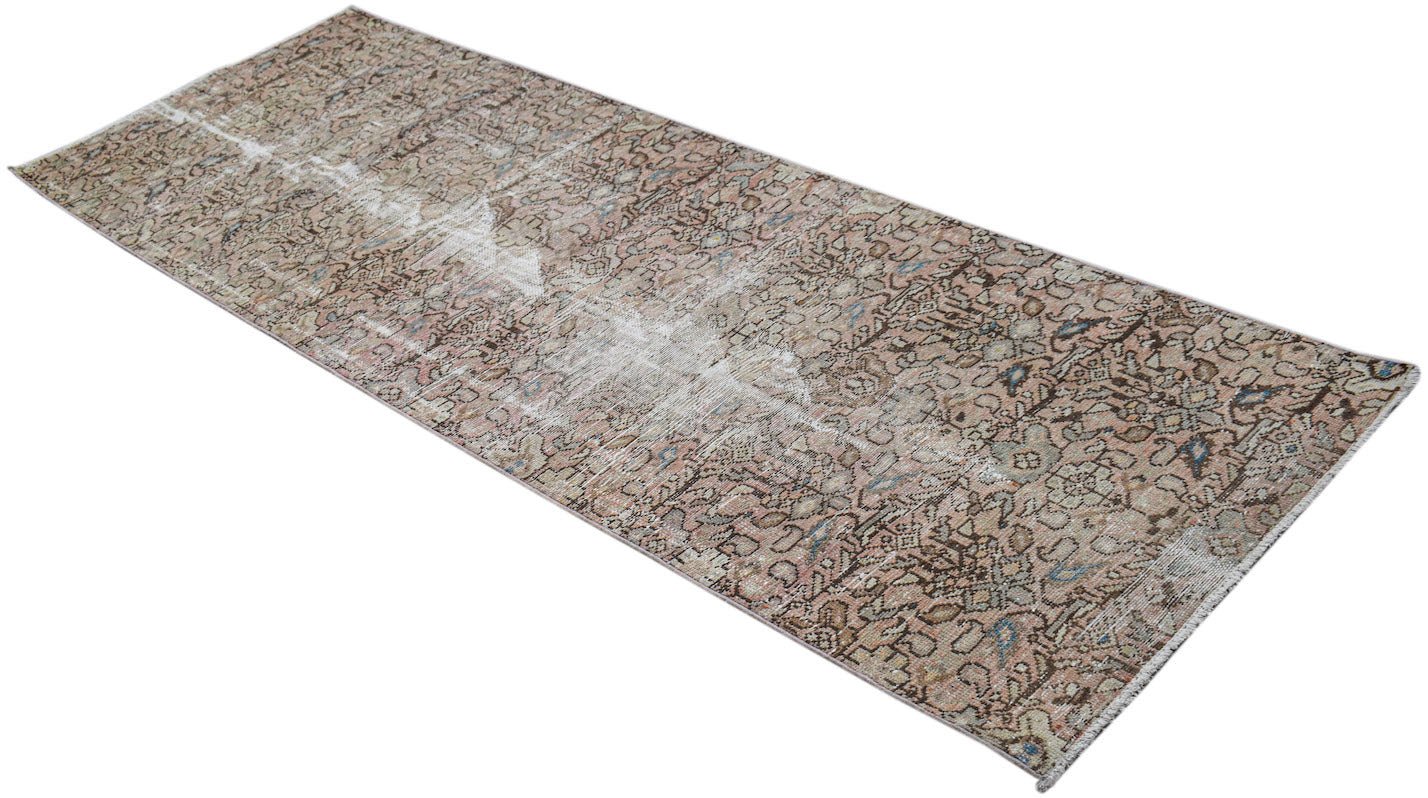 A vintage handwoven Persian Hamadan runner featuring a faded floral pattern in muted earth tones.