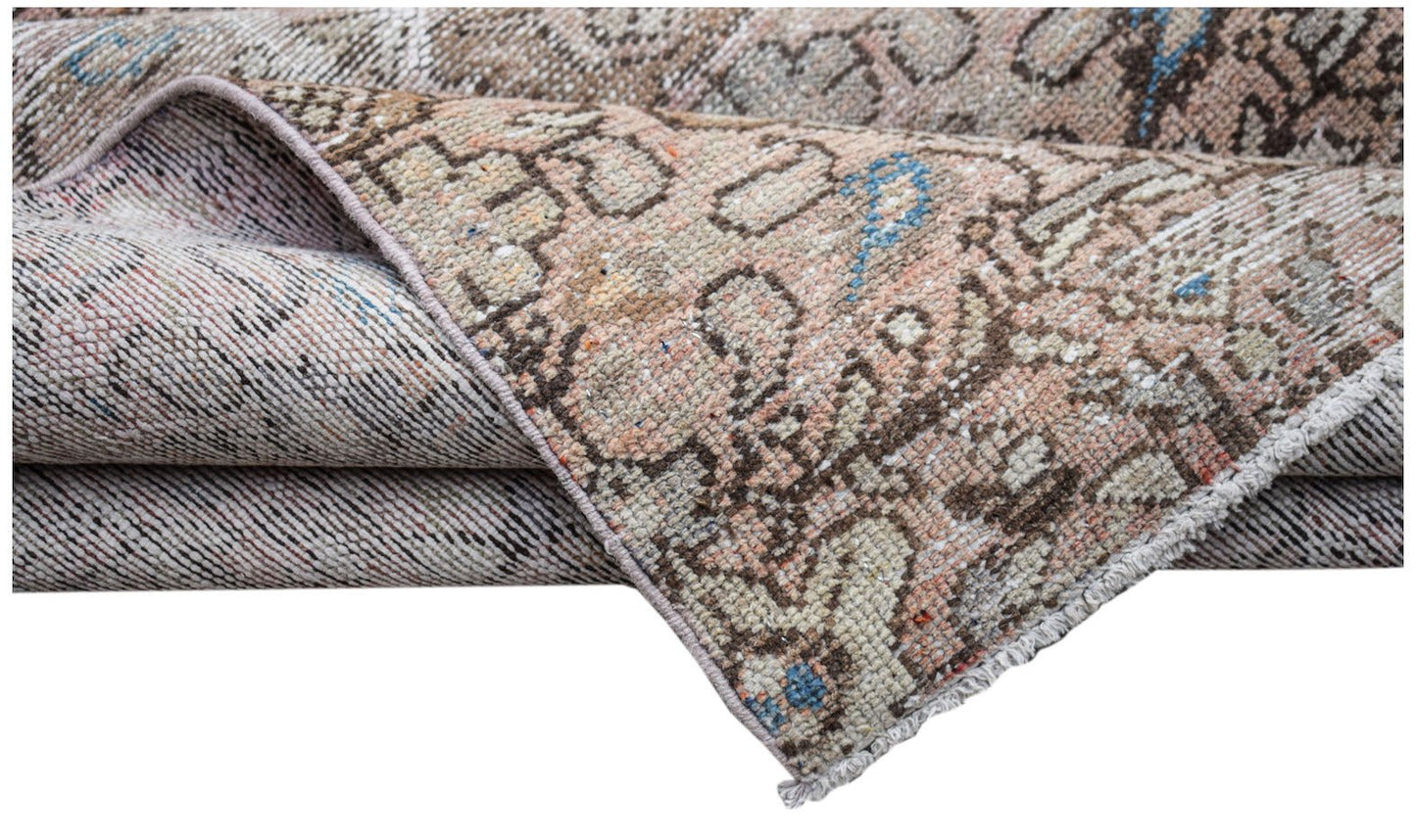 A vintage handwoven Persian Hamadan runner featuring a faded geometric pattern in muted tones.