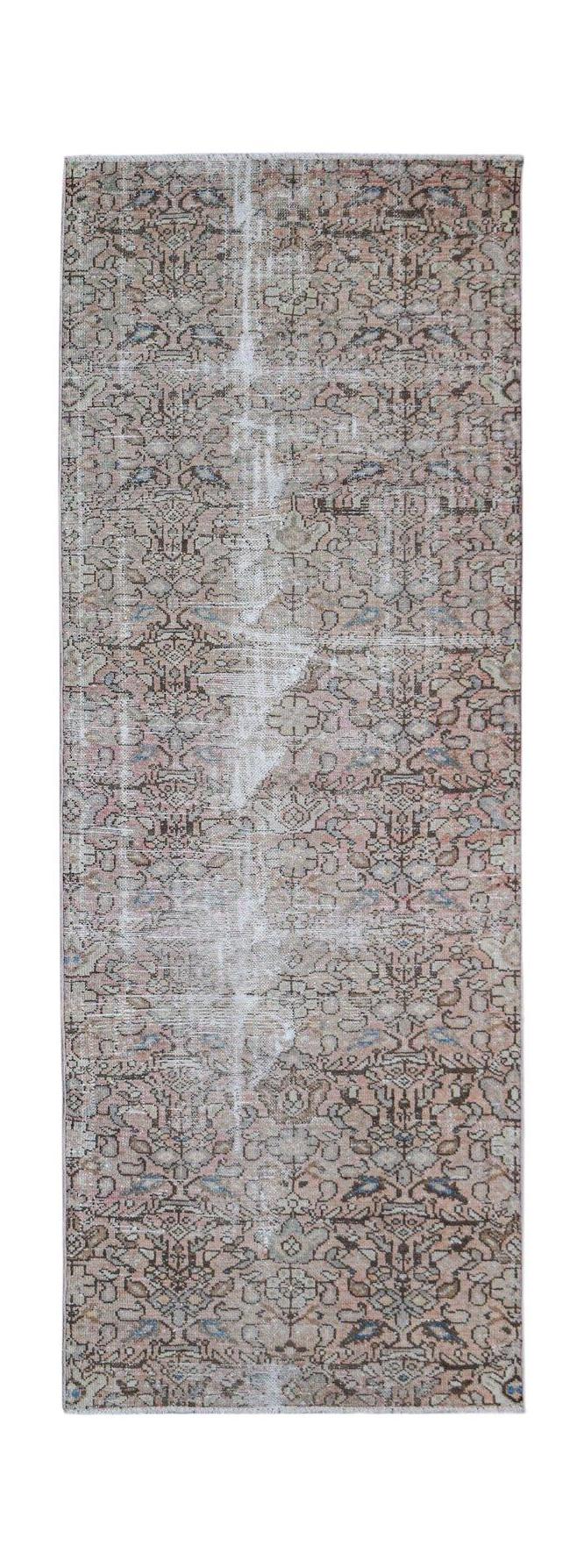 A vintage handwoven Persian Hamadan runner featuring a faded floral pattern in muted earth tones.
