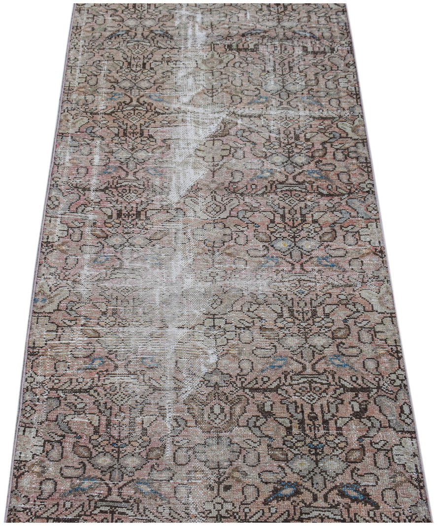 A vintage handwoven Persian Hamadan runner featuring a faded floral pattern in muted earth tones.
