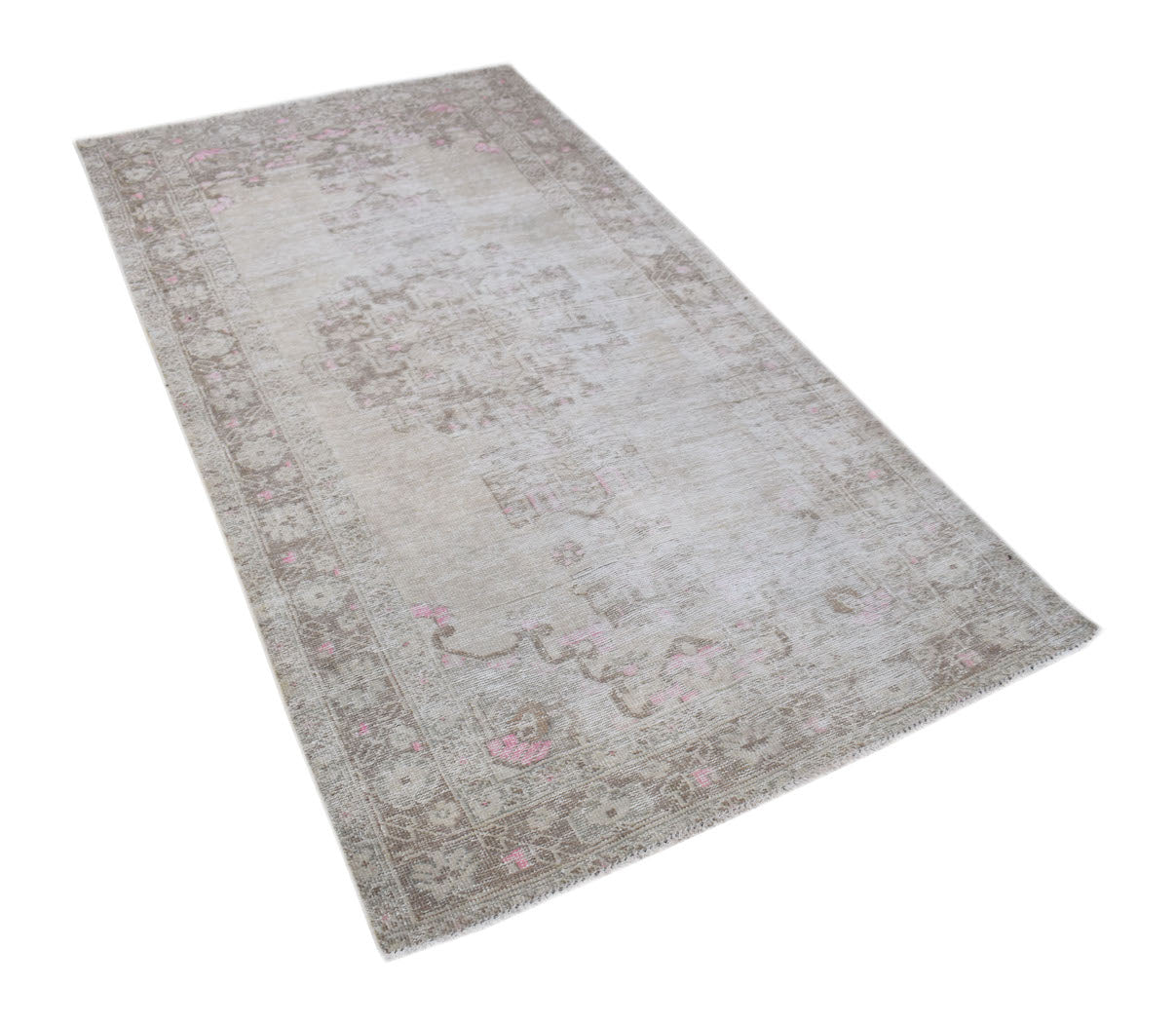 A vintage Persian runner rug featuring a faded beige pattern with subtle pink accents.