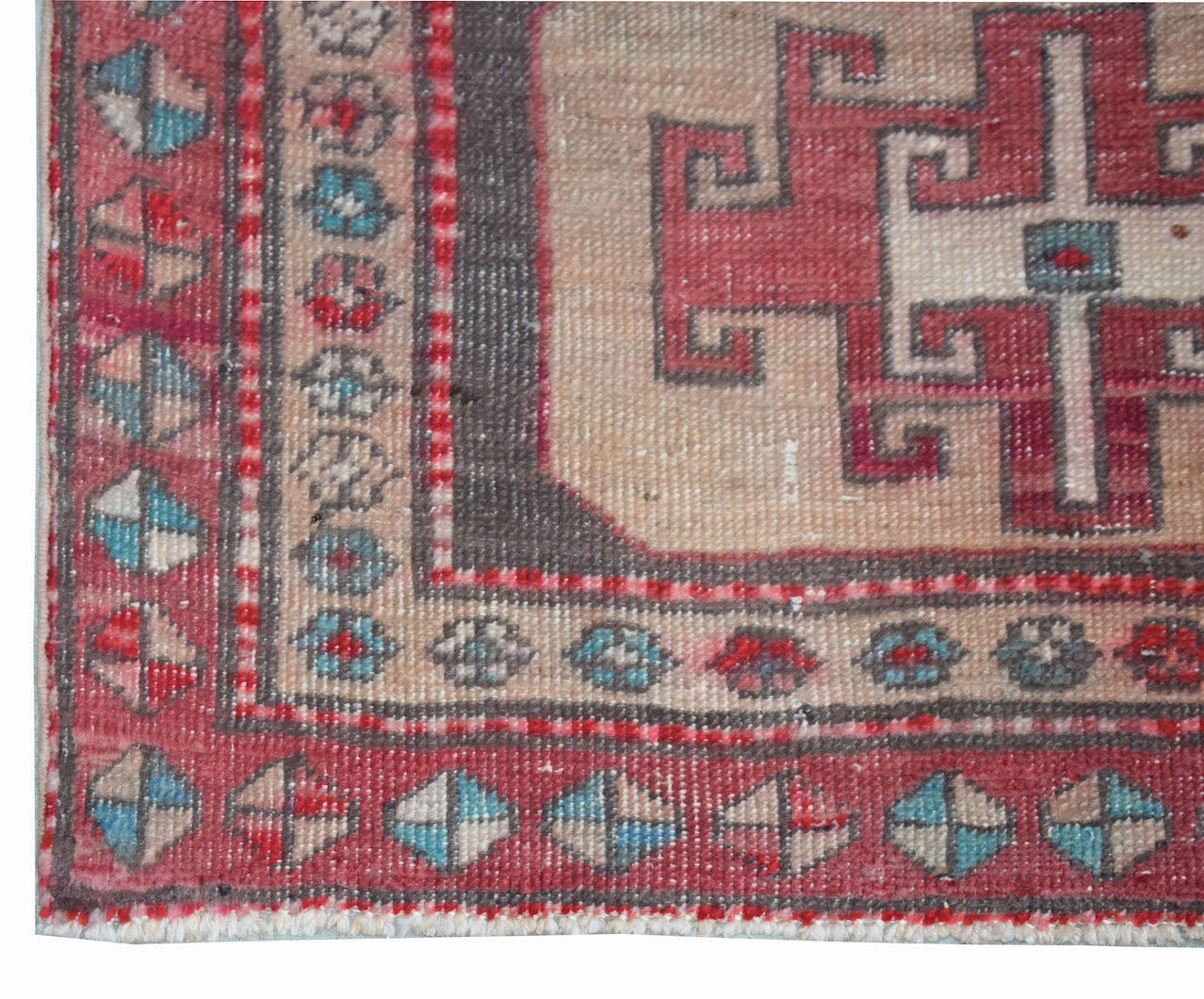 A vintage Persian runner featuring a geometric red and beige pattern with a decorative border.