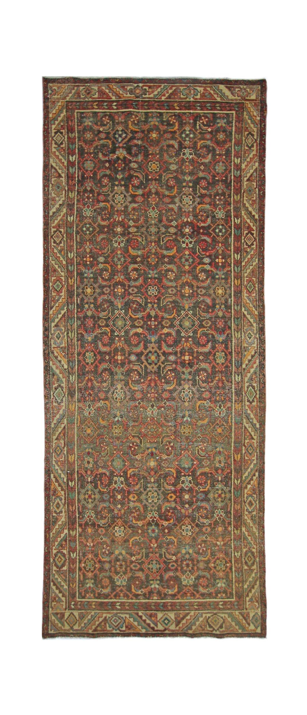 A vintage Persian Hamadan runner rug featuring a dark, intricate floral pattern and geometric border.