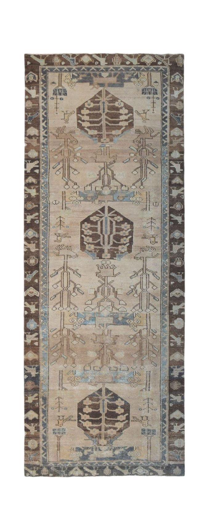 A vintage Persian Hamadan runner featuring geometric tree motifs in brown and blue on a beige field.