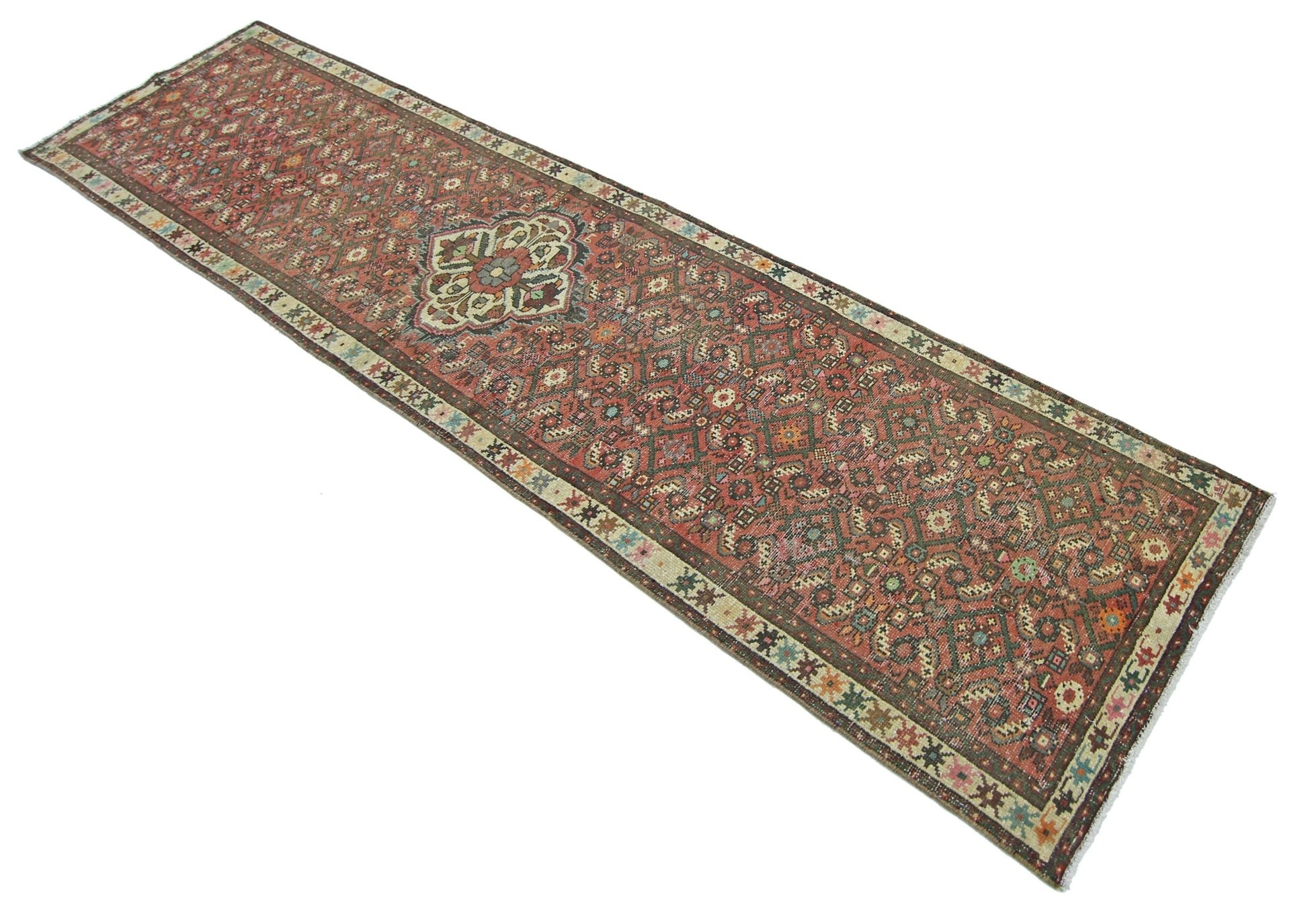 A vintage Persian runner rug featuring a detailed geometric pattern in shades of red and green.