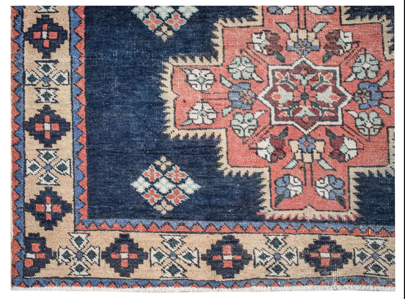 A vintage Persian Ardabil runner featuring a geometric floral medallion on a deep blue field.