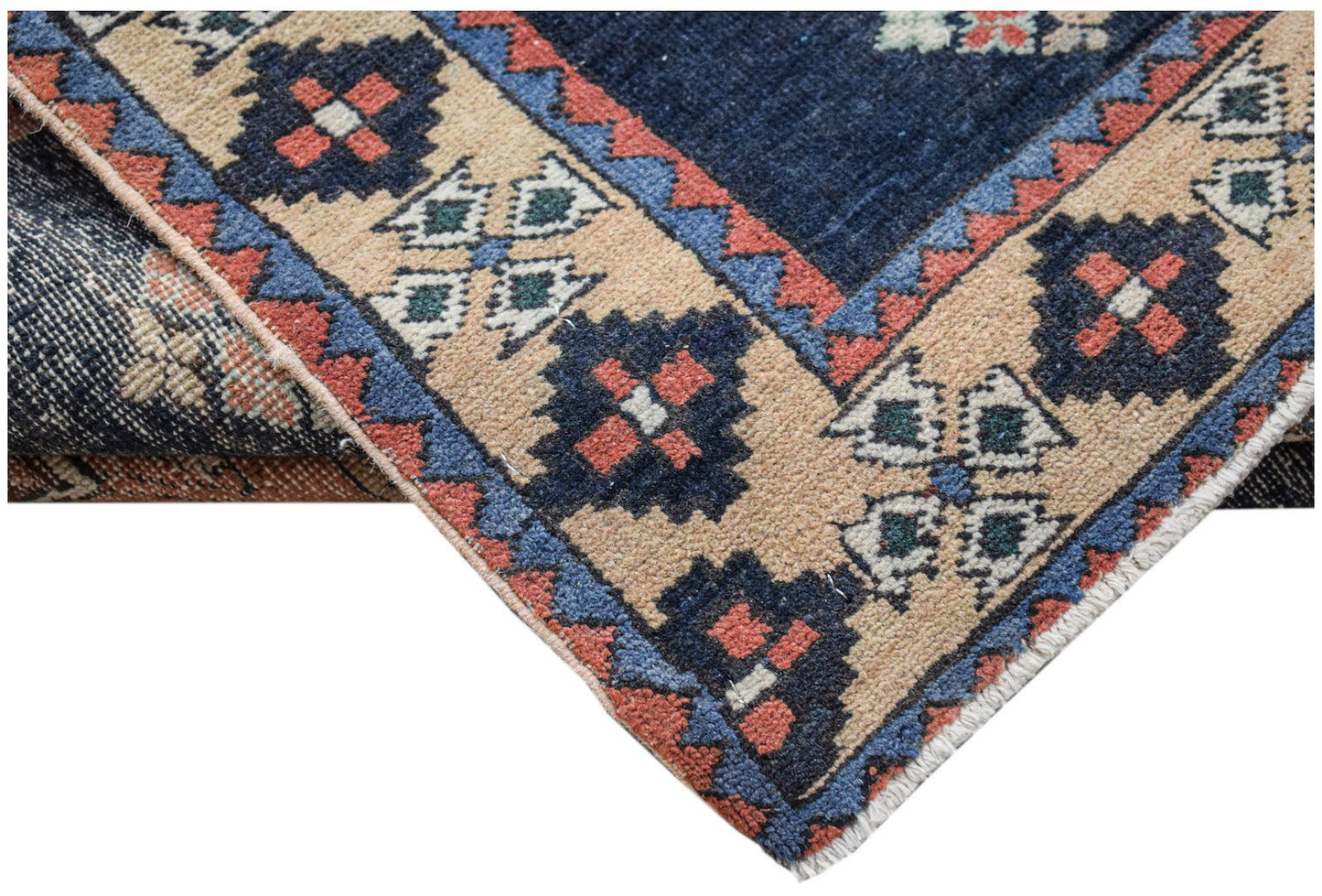 A vintage Persian Ardabil runner featuring a geometric pattern in blue, red, and beige wool.