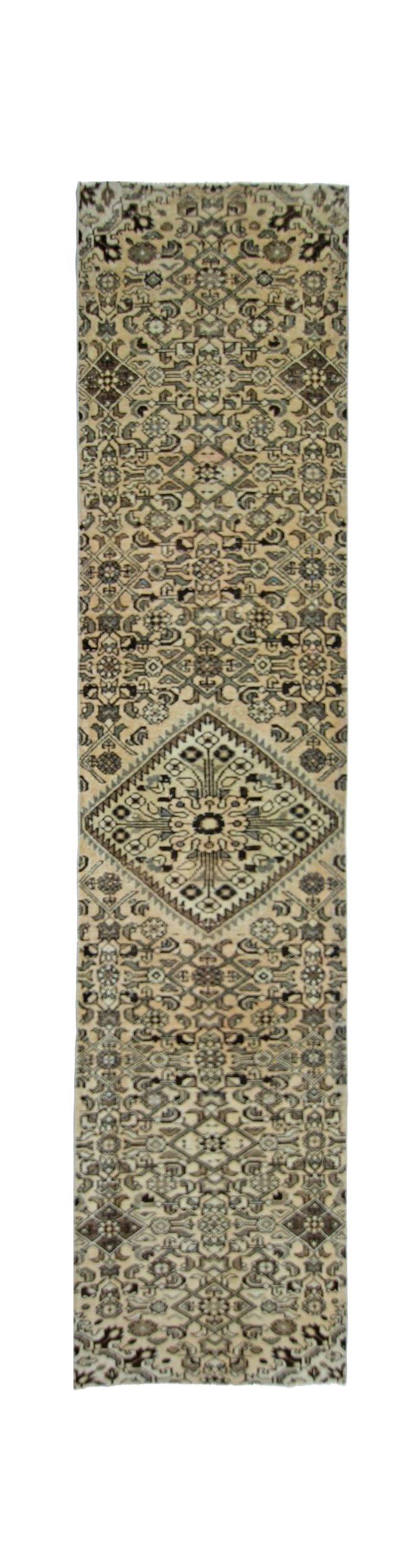 A vintage Persian Hamadan runner rug featuring intricate geometric patterns in neutral tones.