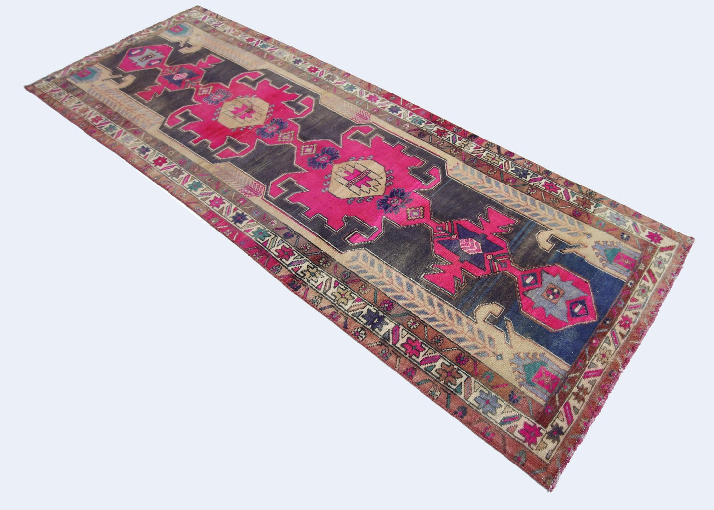 A vintage Persian Hamadan runner featuring geometric patterns in vibrant pink and dark blue tones.