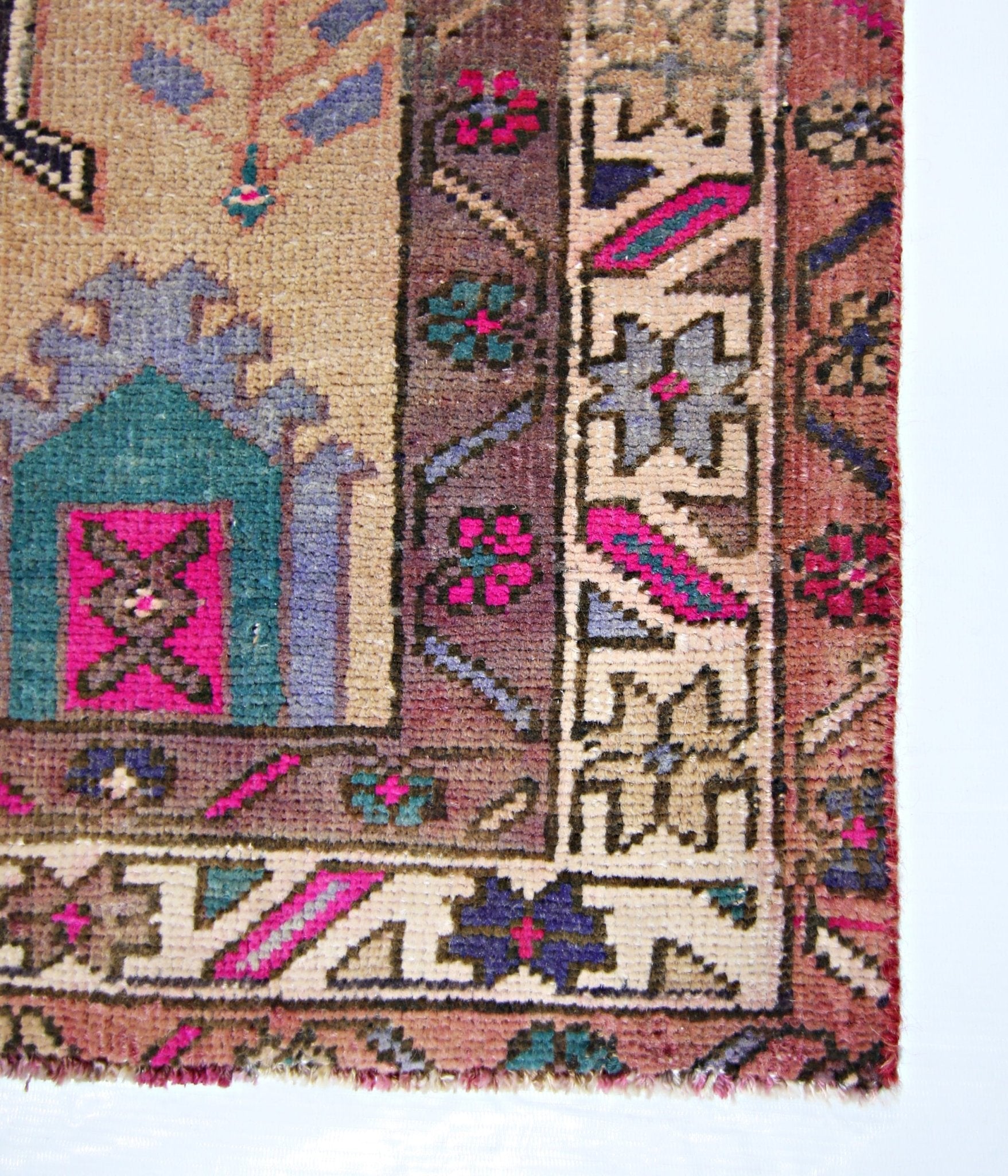A vintage Persian Hamadan runner featuring a geometric floral pattern in vibrant pink and teal.