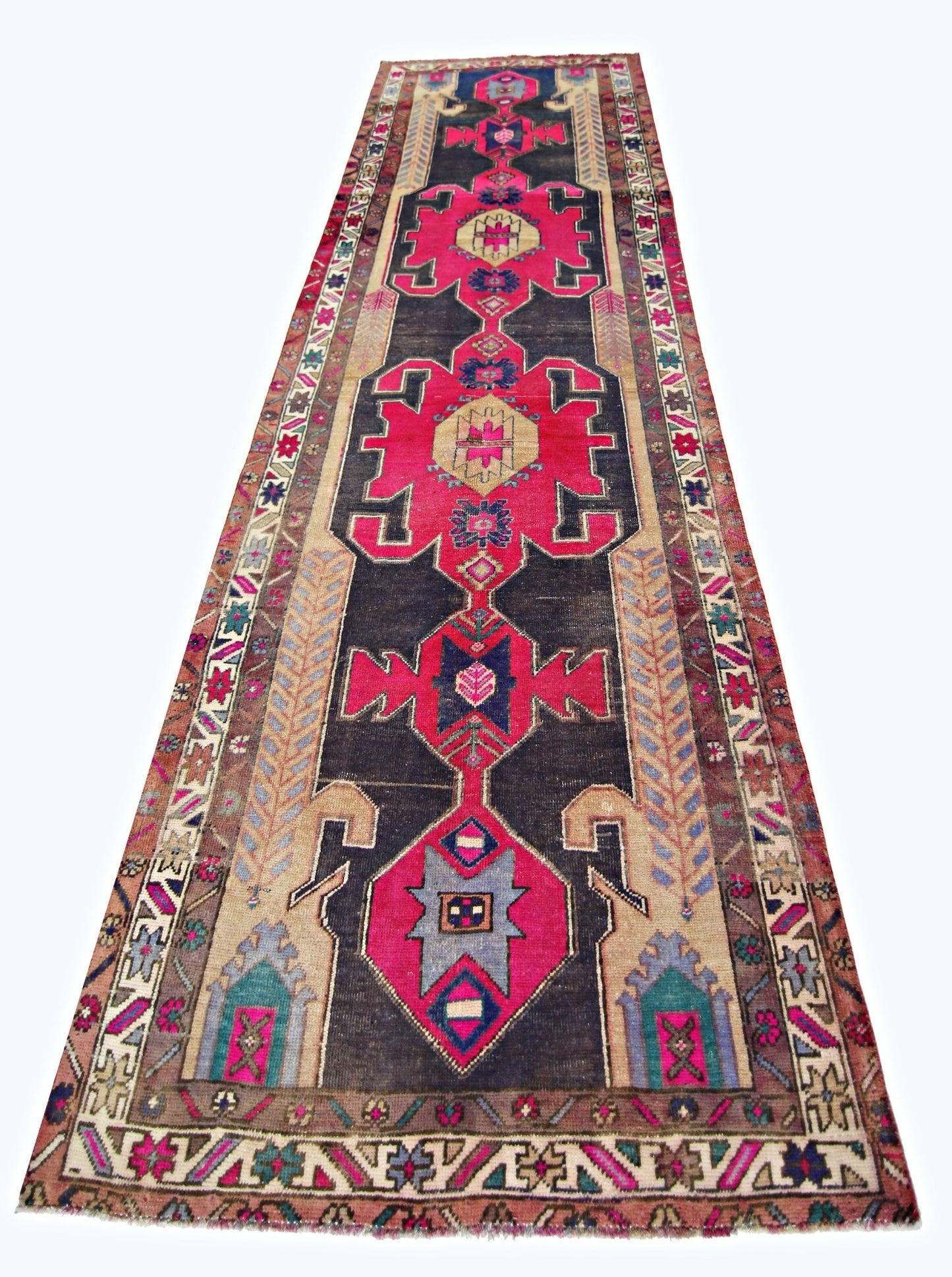 A vintage Persian Hamadan runner featuring geometric medallions in vibrant pink and dark blue.