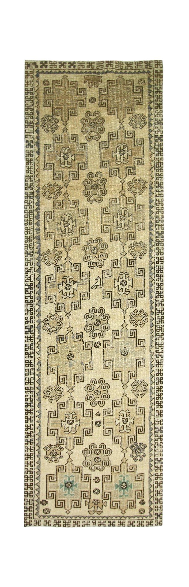 A vintage Turkish Anatolian runner featuring geometric patterns in neutral tones on a wool pile.