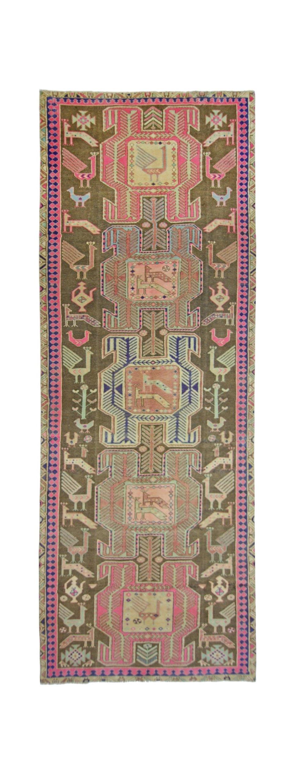 A vintage Persian Ardabil runner featuring a brown field with colorful bird and geometric motifs.