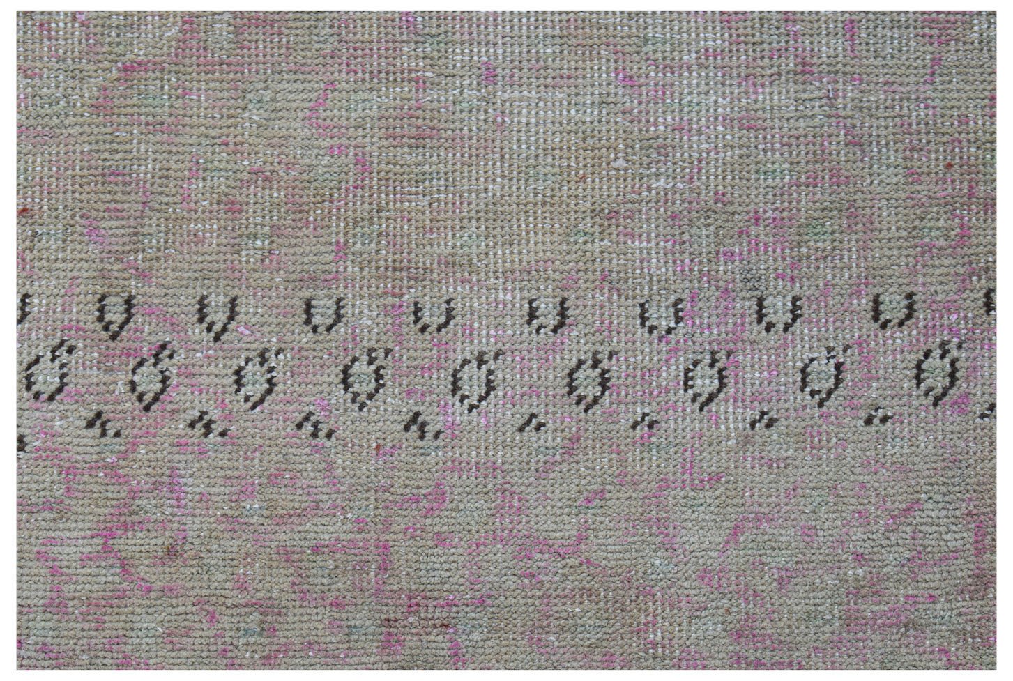 A vintage Persian runner featuring a faded beige and pink field with a dark geometric border.
