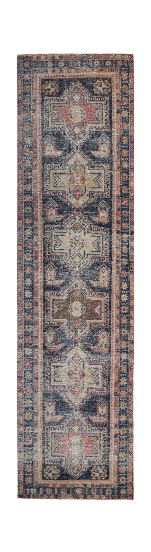 A vintage Persian runner rug featuring a geometric pattern in shades of blue, red, and beige.
