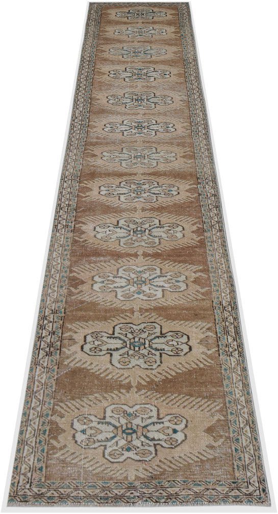 A handwoven vintage Persian Tabriz runner featuring a repeating floral pattern in brown and cream.