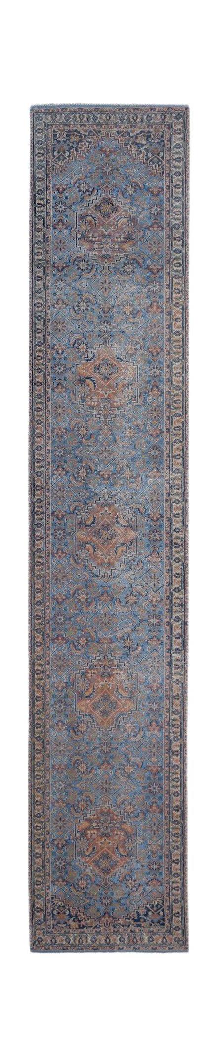 A vintage Persian runner rug featuring intricate floral patterns in shades of blue and rust.
