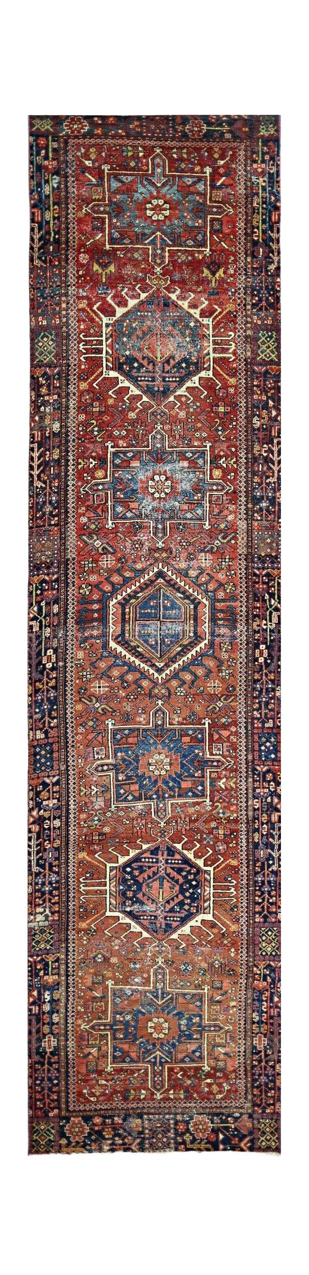 A vintage Persian Karaja runner featuring geometric medallions in red and blue wool.