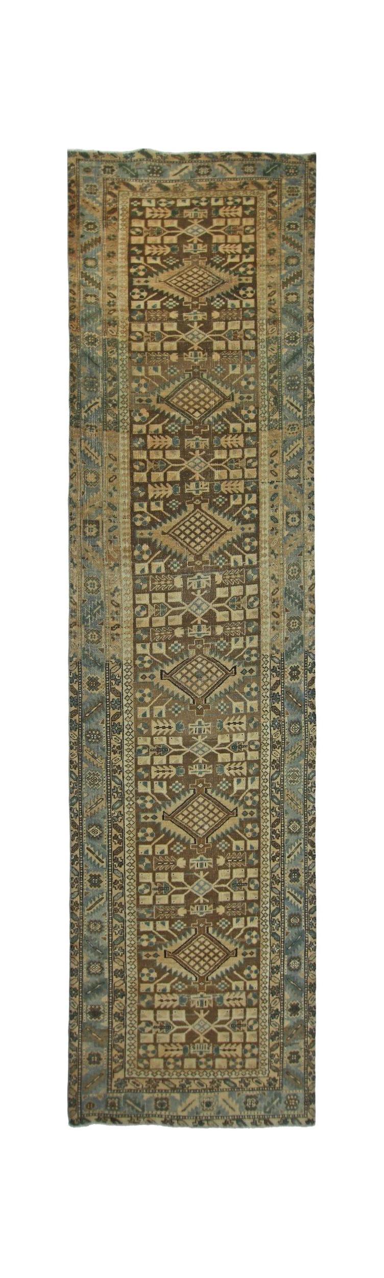 A vintage Persian Malayer runner featuring a geometric diamond pattern in earthy tones.