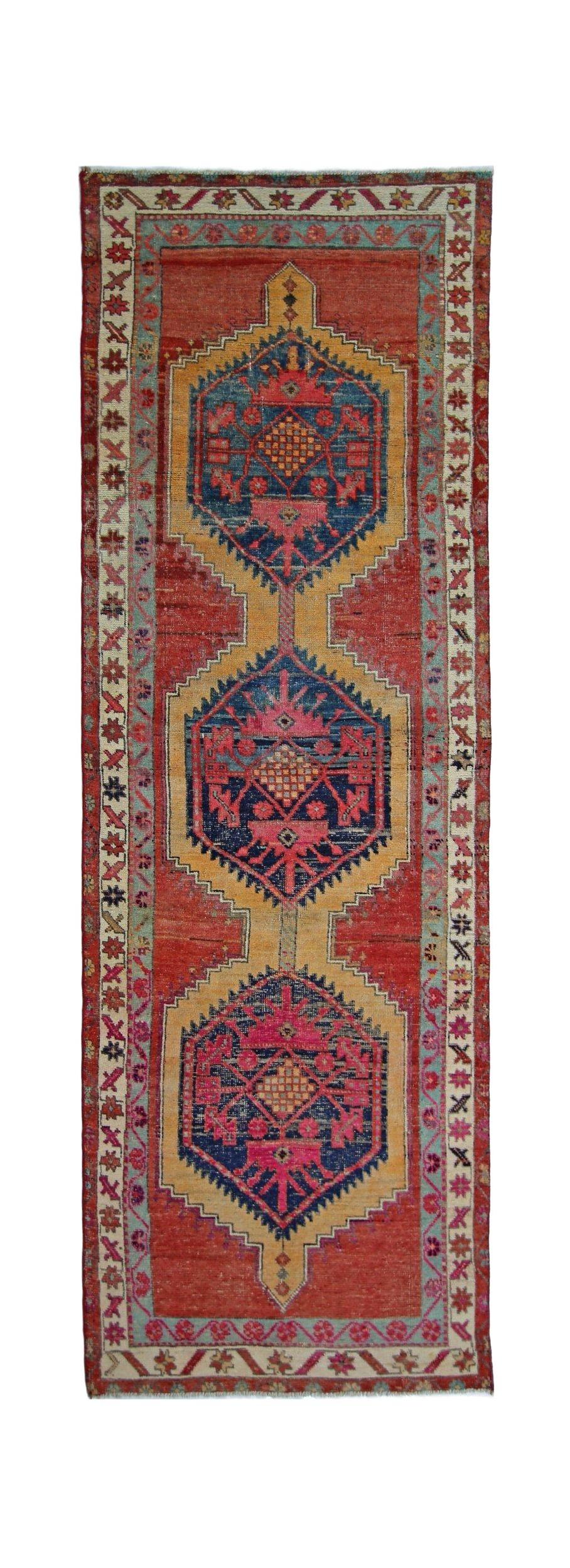 A vintage Persian Hamadan runner featuring three geometric medallions in red, blue, and gold.