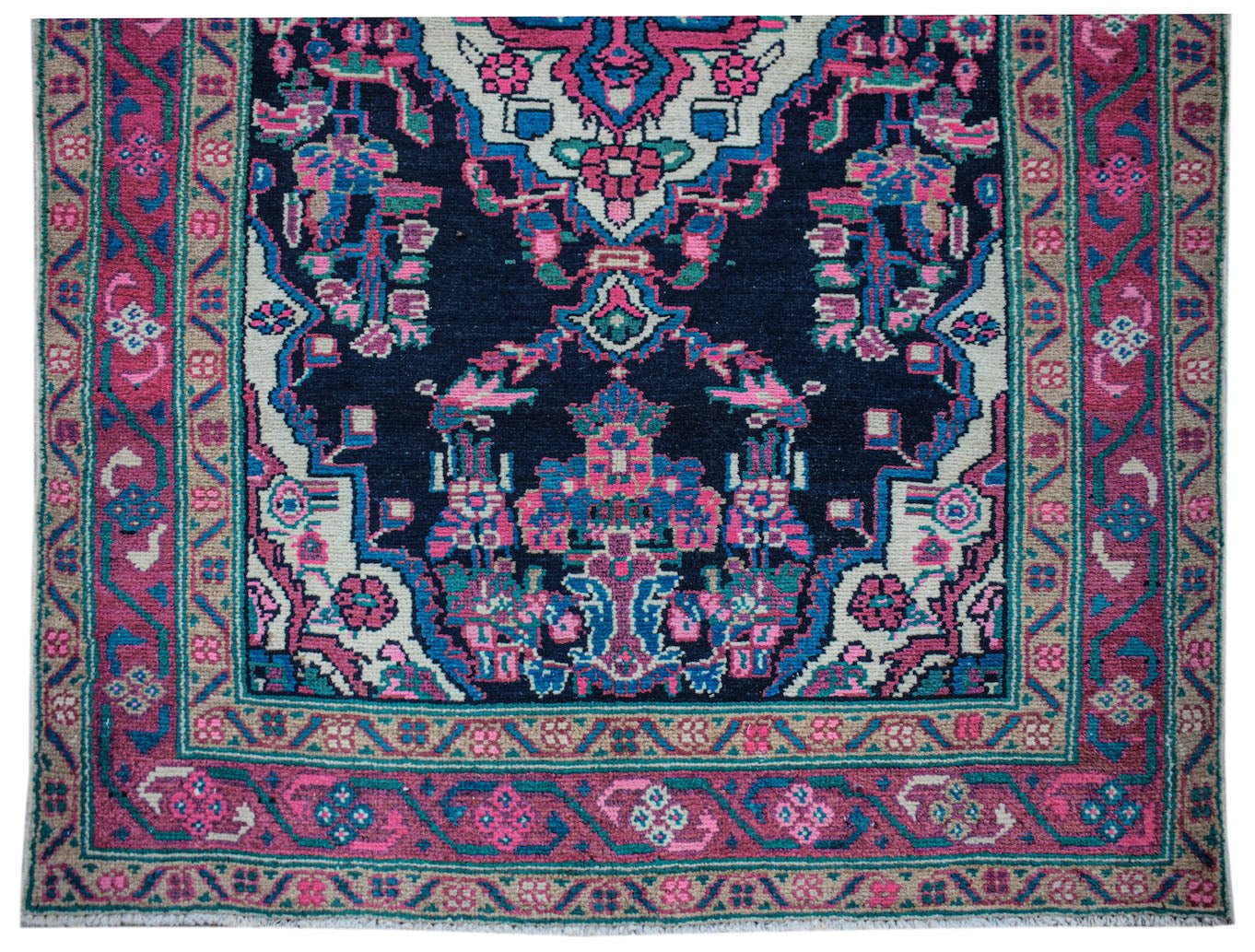 A vintage Persian Hamadan runner featuring a dark blue field with vibrant pink and teal patterns.